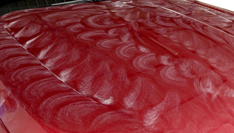 Wax swirls on red vehicle panel